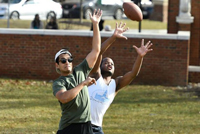 two-students-catching-a-football-fall.jpg