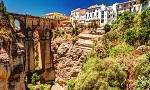 houses along a rocky cliff with bridge