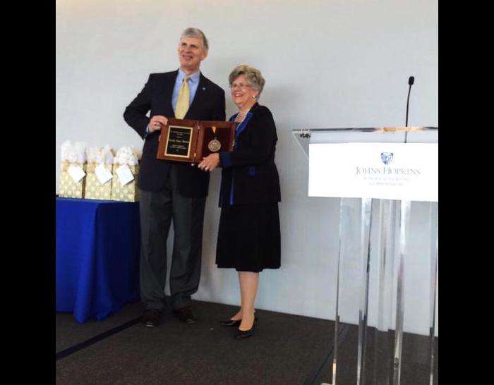 Jay Lenrow presents Distinguished Alumna Award